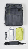 A textured black InTransit convertible travel bag shown w/ insulated food container, accessory bag, shoulder strap & carabiner attachment.