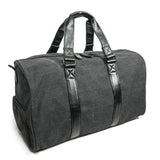 A charcoal cotton canvas duffel w/ black leather trim, inner lining & shoe compartment
