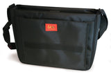 An open green 15.4" Maddie Powers Pulp Fiction Messenger bag w/ pulp magazine images from the 40s and 50s on the front, built-in cell phone pouch & interior pockets, plush velveteen trim & a cushioned shoulder strap.
