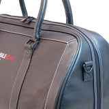 A black leather duffel w/ ruggedized bottom panel & matching leather shoulder strap