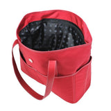An open large red ballistic nylon Sumo Large Tote / diaper bag w/ white stitching, faux-leather detail, Interior & Exterior pockets all around, Magnetic Closures & Printed liner