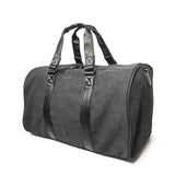 A charcoal cotton canvas duffel w/ black leather trim, inner lining & shoe compartment