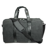 A charcoal cotton canvas duffel w/ black leather trim, inner lining & shoe compartment