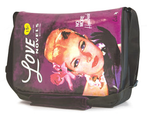 This is a purple 15.4" Maddie Powers Pulp Fiction Messenger bag w/ pulp magazine images from the 40s & 50s on the front, built-in cell phone pouch & plenty of interior pockets, plush velveteen trim & cushioned shoulder strap. 