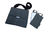 A grey in-flight travel organizer TAB messenger V2 bag w/ black shoulder strap shown w/ 2 insert bags for cords, boarding pass & small essentials, TSA clear bag