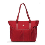 A large red ballistic nylon Sumo Large Tote / diaper bag w/ white stitching, faux-leather detail, Interior & Exterior pockets all around, Magnetic Closures & Printed liner