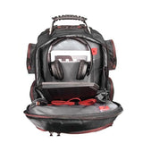 An open ballistic nylon black 16" Gaming Checkpoint Friendly Backpack w/ red trim & velcro front panel, padded air-mesh shoulder straps & back panel, padded carry handle & trolley strap for stacking on other luggage. Shows headphones, tablet & tech gear.
