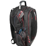 A side view of ballistic nylon black 16" Gaming Checkpoint Friendly Backpack w/ red trim & velcro front panel, padded air-mesh shoulder straps & back panel, padded carry handle & trolley strap for stacking on other luggage. Shows embedded USB port & exterior pockets.