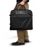A man carrying a black Traveler's Folding Garment Bag made of 900D Ballistic Nylon w/ heavy duty zippers & fittings
