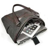 An open charcoal 15.6" Urban Laptop Tote w/ brown leather trim, handles, & padded computer compartment.